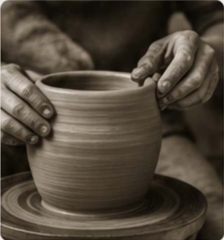Artisan hands shaping a ceramic pot on a pottery wheel